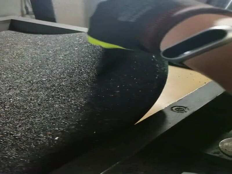 person cleaning rubber floor with a microfiber mop